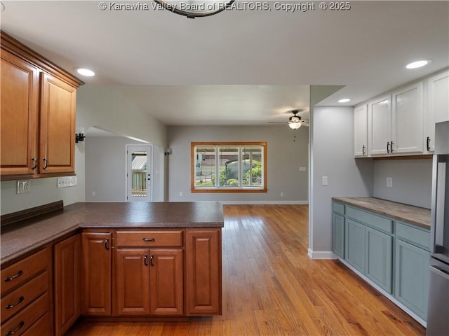 9012 Florida Ave, Marmet, WV 25315 - kitchen with a peninsula, a ceiling fan, light wood-type flooring, recessed lighting, and dark countertops