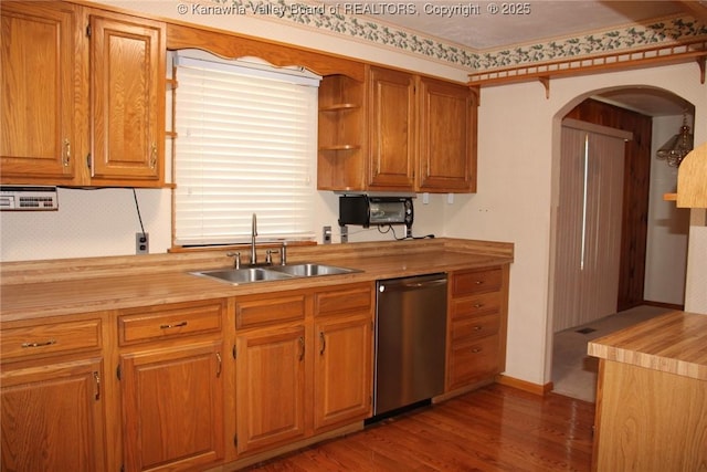 401 Green Acres Dr, Hurricane, WV 25526 - kitchen with stainless steel dishwasher, wood finished floors, arched walkways, and brown cabinets