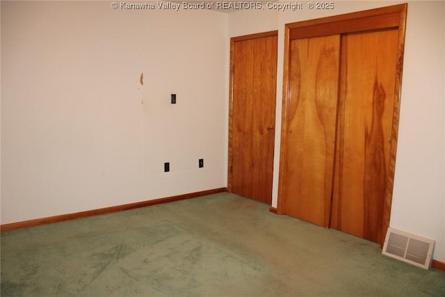 401 Green Acres Dr, Hurricane, WV 25526 - unfurnished bedroom featuring carpet and two closets