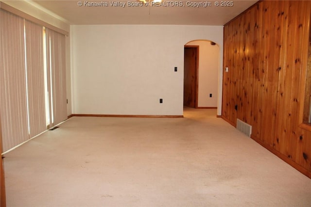 401 Green Acres Dr, Hurricane, WV 25526 - carpeted empty room featuring arched walkways and wood walls