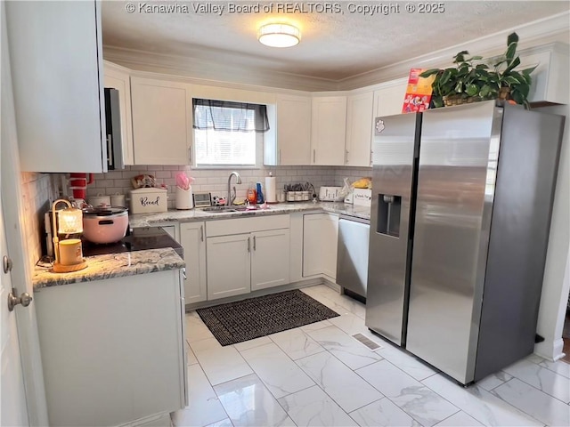602 43rd St SE, Charleston, WV 25304 - kitchen featuring stainless steel appliances, light marble finish flooring, backsplash, light stone countertops, and white cabinets