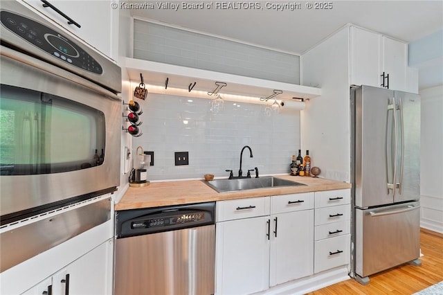 815 Chappell Rd, Charleston, WV 25304 - kitchen featuring stainless steel appliances, decorative backsplash, white cabinets, and a warming drawer