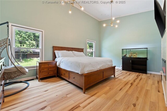 815 Chappell Rd, Charleston, WV 25304 - bedroom with a towering ceiling, light wood-style flooring, crown molding, and a chandelier