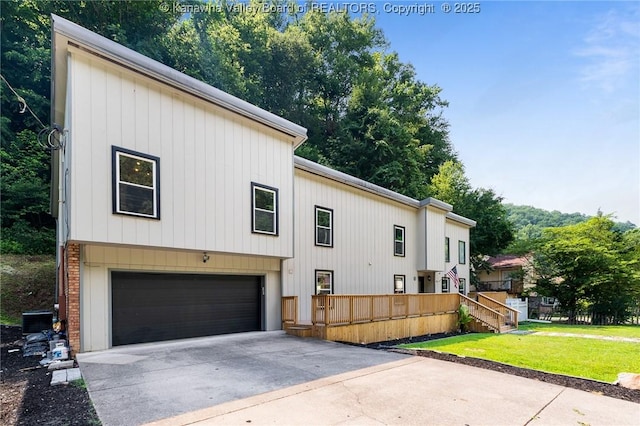815 Chappell Rd, Charleston, WV 25304 - view of side of property featuring driveway, a garage, and a lawn