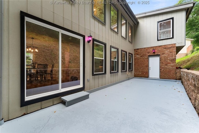 815 Chappell Rd, Charleston, WV 25304 - rear view of house with a patio area, brick siding, and board and batten siding