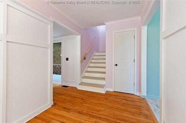 815 Chappell Rd, Charleston, WV 25304 - hallway with light wood-type flooring, ornamental molding, and stairway