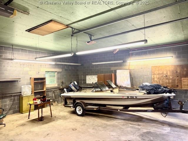5490 Fisher Bowen Branch Rd, Wayne, WV 25570 - garage featuring concrete block wall and a garage door opener