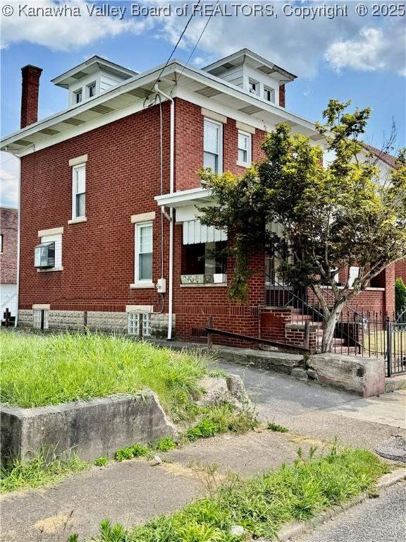 406 Elm St, Charleston, WV 25302 - view of home's exterior featuring brick siding and a chimney
