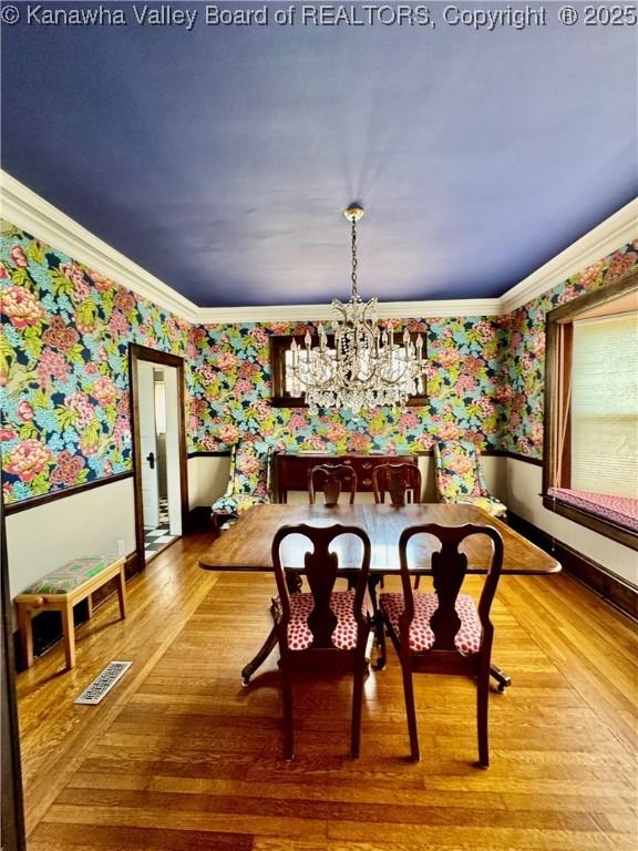 406 Elm St, Charleston, WV 25302 - dining area with wallpapered walls, a chandelier, ornamental molding, and wood finished floors