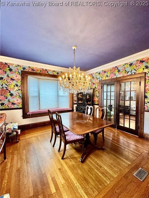 406 Elm St, Charleston, WV 25302 - dining space featuring ornamental molding, wood finished floors, a chandelier, and wallpapered walls