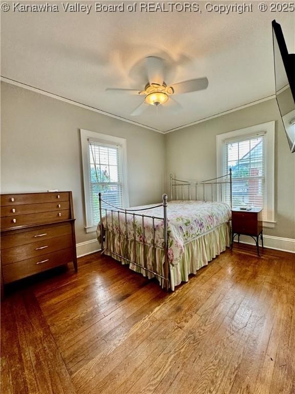 406 Elm St, Charleston, WV 25302 - bedroom with multiple windows, dark wood-style flooring, crown molding, and a ceiling fan