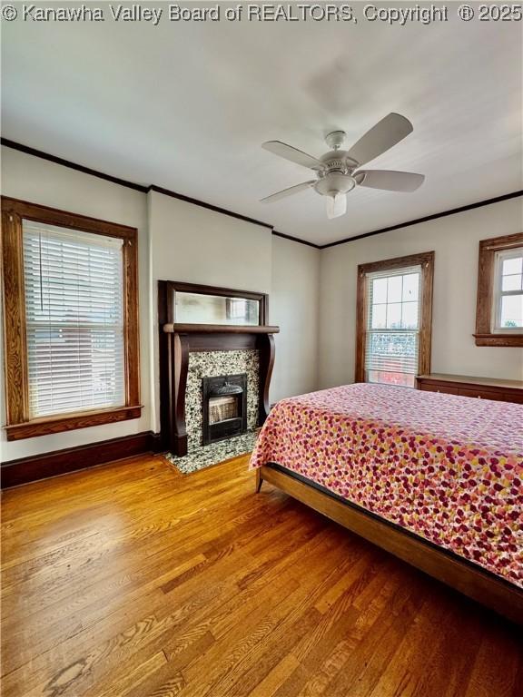 406 Elm St, Charleston, WV 25302 - bedroom featuring ornamental molding, wood finished floors, and a fireplace with flush hearth