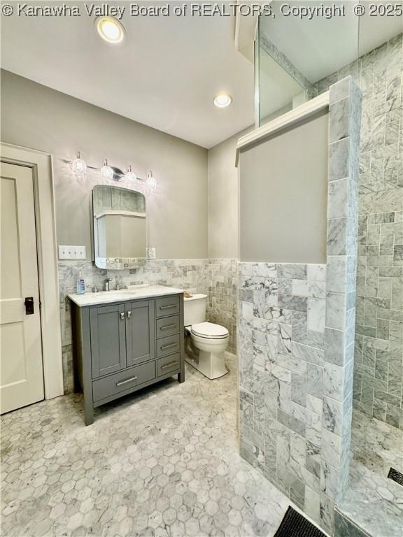 406 Elm St, Charleston, WV 25302 - full bathroom featuring tile walls, vanity, a walk in shower, wainscoting, and recessed lighting