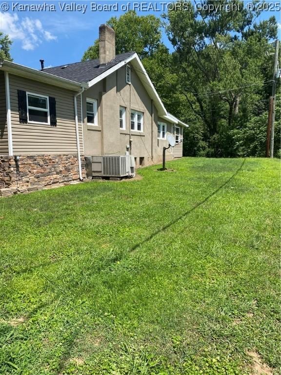 42 Pine Cone Rd, Elkview, WV 25071 - view of side of property featuring a chimney, a lawn, stone siding, stucco siding, and a shingled roof
