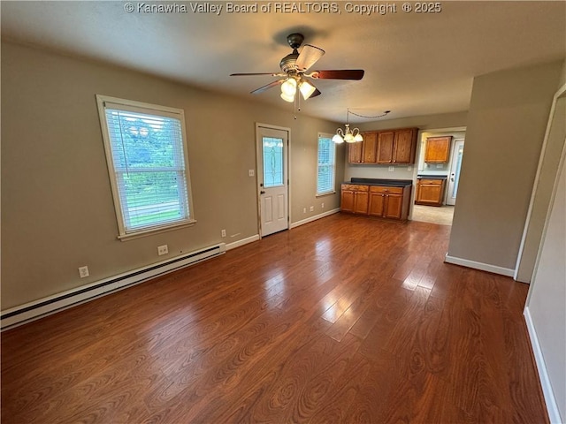 913 Charleston Rd, Point Pleasant, WV 25550 - unfurnished living room featuring a baseboard radiator, a chandelier, ceiling fan, and dark wood-style flooring