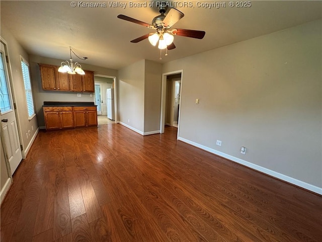 913 Charleston Rd, Point Pleasant, WV 25550 - kitchen with brown cabinets, a chandelier, dark countertops, dark wood-type flooring, and a ceiling fan