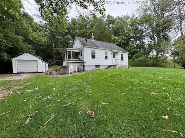 913 Charleston Rd, Point Pleasant, WV 25550 - view of side of home featuring a yard, a detached garage, a chimney, a sunroom, and a storage shed