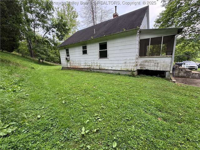 913 Charleston Rd, Point Pleasant, WV 25550 - view of property exterior featuring a sunroom, a lawn, and a chimney