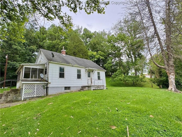 913 Charleston Rd, Point Pleasant, WV 25550 - rear view of property featuring a sunroom, a yard, and a chimney