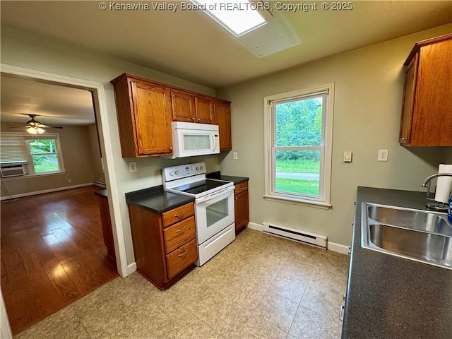 913 Charleston Rd, Point Pleasant, WV 25550 - kitchen featuring white appliances, a baseboard radiator, dark countertops, brown cabinetry, and ceiling fan