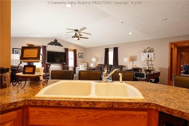 8 Anchors Way, Winfield, WV 25213 - kitchen with lofted ceiling, ceiling fan, open floor plan, recessed lighting, and brown cabinetry
