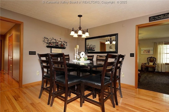 8 Anchors Way, Winfield, WV 25213 - dining room featuring a chandelier, wood finished floors, and a textured ceiling