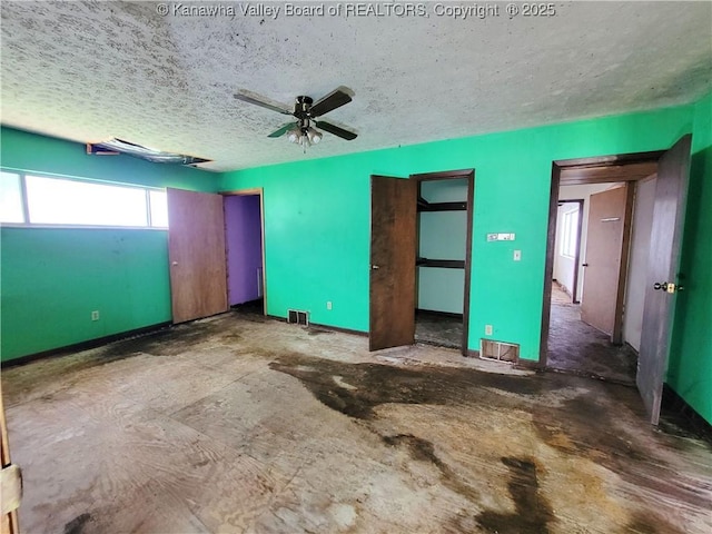 200 Boone St, Saint Albans, WV 25177 - unfurnished bedroom featuring two closets, a ceiling fan, and a textured ceiling