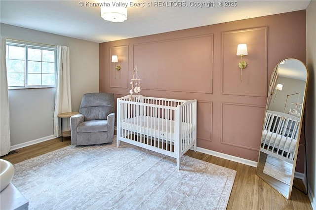 5301 Balsam Cir, Charleston, WV 25313 - bedroom featuring wood finished floors and a crib