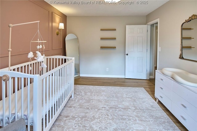 5301 Balsam Cir, Charleston, WV 25313 - bedroom with wood finished floors, a crib, and arched walkways