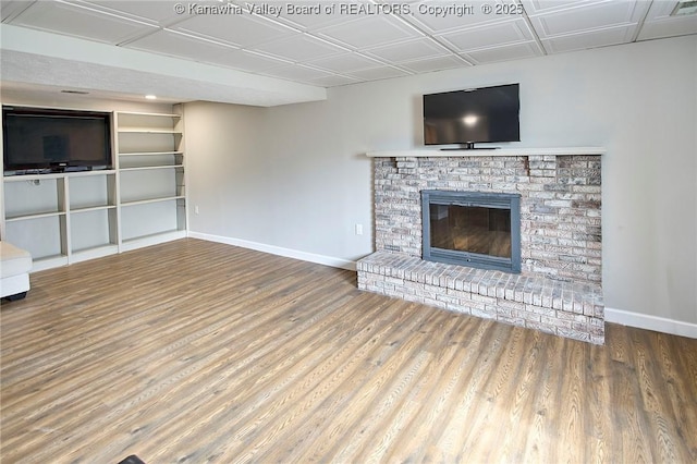 5301 Balsam Cir, Charleston, WV 25313 - unfurnished living room with wood finished floors, a brick fireplace, and an ornate ceiling