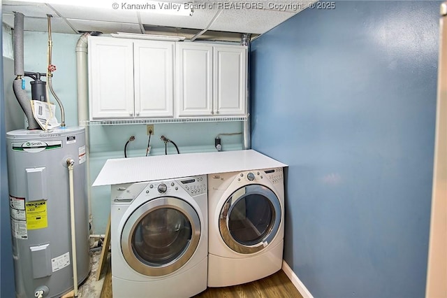 5301 Balsam Cir, Charleston, WV 25313 - washroom with water heater, washing machine and dryer, cabinet space, and wood finished floors