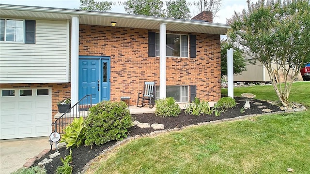 5301 Balsam Cir, Charleston, WV 25313 - view of exterior entry featuring brick siding, a chimney, a lawn, an attached garage, and driveway