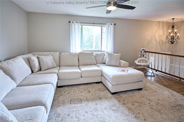 5301 Balsam Cir, Charleston, WV 25313 - living room featuring a ceiling fan, wood finished floors, and a chandelier