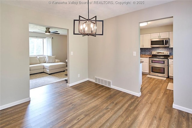 5301 Balsam Cir, Charleston, WV 25313 - dining space with dark wood-style floors, ceiling fan, and a chandelier
