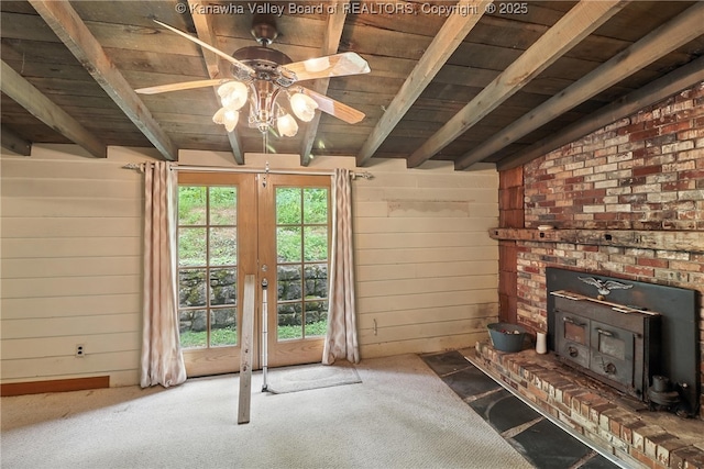 3223 Georges Dr, Saint Albans, WV 25177 - unfurnished living room featuring a wooden ceiling with exposed beams, carpet flooring, ceiling fan, a wood stove, and wood walls