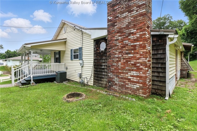 3223 Georges Dr, Saint Albans, WV 25177 - view of property exterior with a lawn, a porch, and a chimney