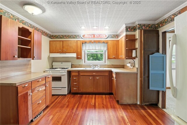 3223 Georges Dr, Saint Albans, WV 25177 - kitchen with open shelves, white gas range, under cabinet range hood, light wood-style flooring, and brown cabinets