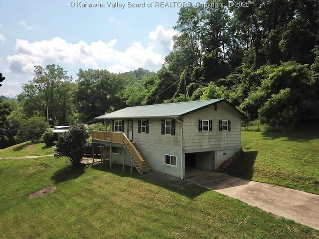 61 Sol Ln, Charleston, WV 25312 - rear view of house with stairway, concrete driveway, a wooden deck, a lawn, and an attached garage