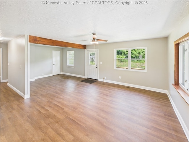 61 Sol Ln, Charleston, WV 25312 - unfurnished living room with a textured ceiling, ceiling fan, and wood finished floors