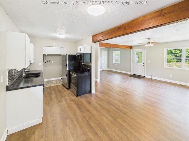 61 Sol Ln, Charleston, WV 25312 - kitchen featuring appliances with stainless steel finishes, white cabinetry, wood finished floors, a textured ceiling, and dark countertops