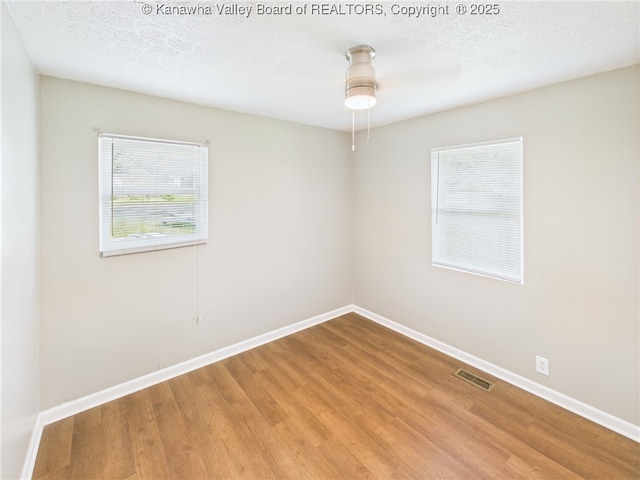 61 Sol Ln, Charleston, WV 25312 - spare room featuring healthy amount of natural light, wood finished floors, a ceiling fan, and a textured ceiling
