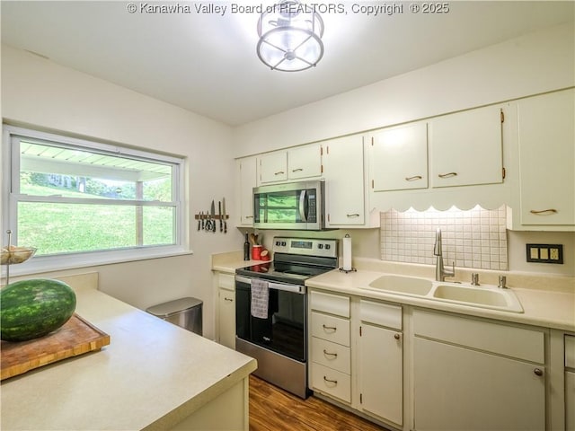 806 Whispering Way S, Charleston, WV 25303 - kitchen featuring appliances with stainless steel finishes, light countertops, wood finished floors, decorative backsplash, and white cabinetry