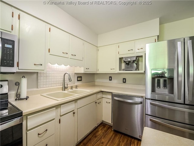806 Whispering Way S, Charleston, WV 25303 - kitchen featuring appliances with stainless steel finishes, dark wood-type flooring, light countertops, decorative backsplash, and white cabinetry