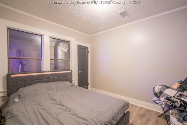 512 Maxwell St, Charleston, WV 25311 - bedroom with wood finished floors, a textured ceiling, and crown molding