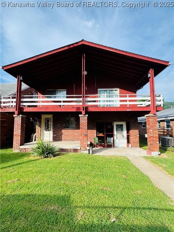 8612 Maryland Ave, Marmet, WV 25315 - rear view of property with a yard, a deck, and brick siding