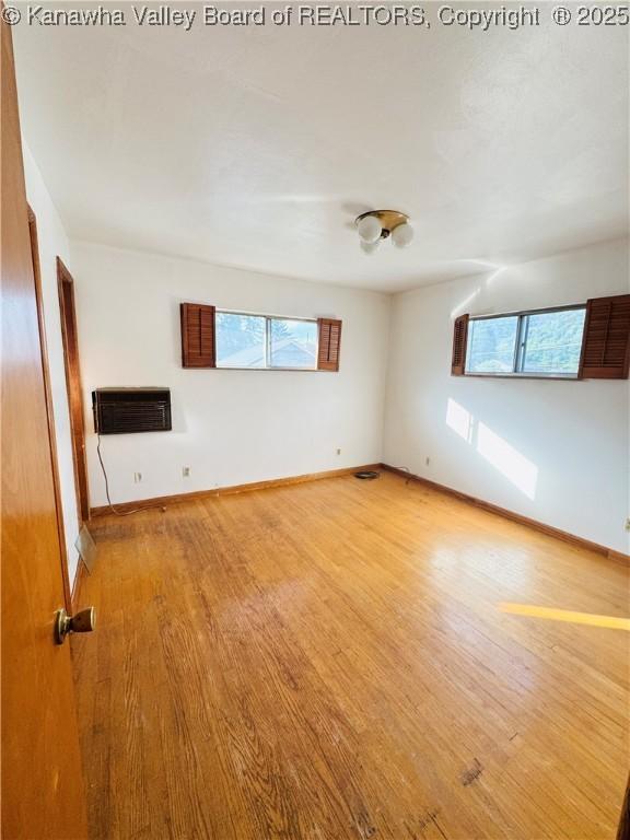 8612 Maryland Ave, Marmet, WV 25315 - spare room with light wood-style floors, plenty of natural light, and a wall mounted air conditioner