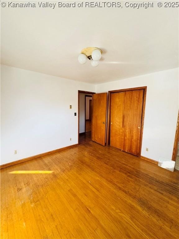8612 Maryland Ave, Marmet, WV 25315 - unfurnished bedroom with a closet and wood finished floors