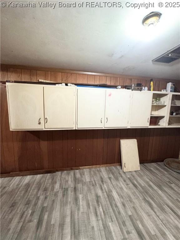 8612 Maryland Ave, Marmet, WV 25315 - kitchen with wood finished floors, wood walls, open shelves, and white cabinetry