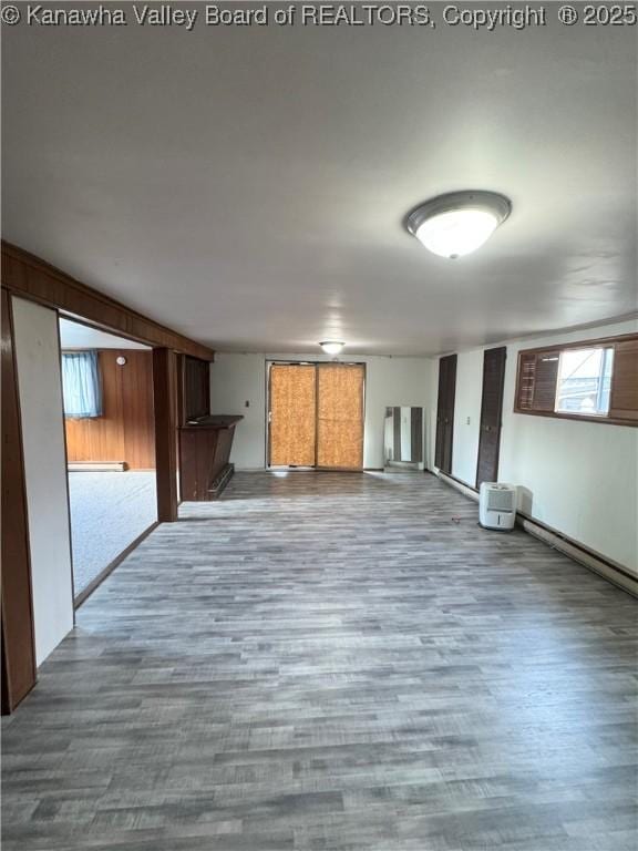 8612 Maryland Ave, Marmet, WV 25315 - unfurnished living room with wood finished floors and a baseboard heating unit