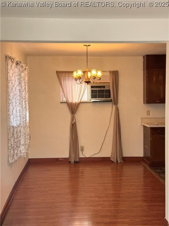 8612 Maryland Ave, Marmet, WV 25315 - unfurnished dining area with wood finished floors, a chandelier, and a wall unit AC